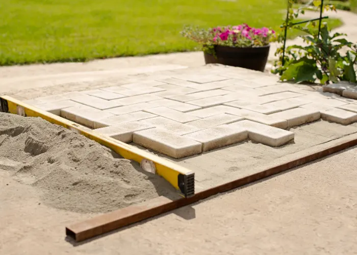 A landscaper installing a new paver walkway