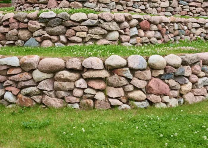 A retaining wall made from a variety of stones